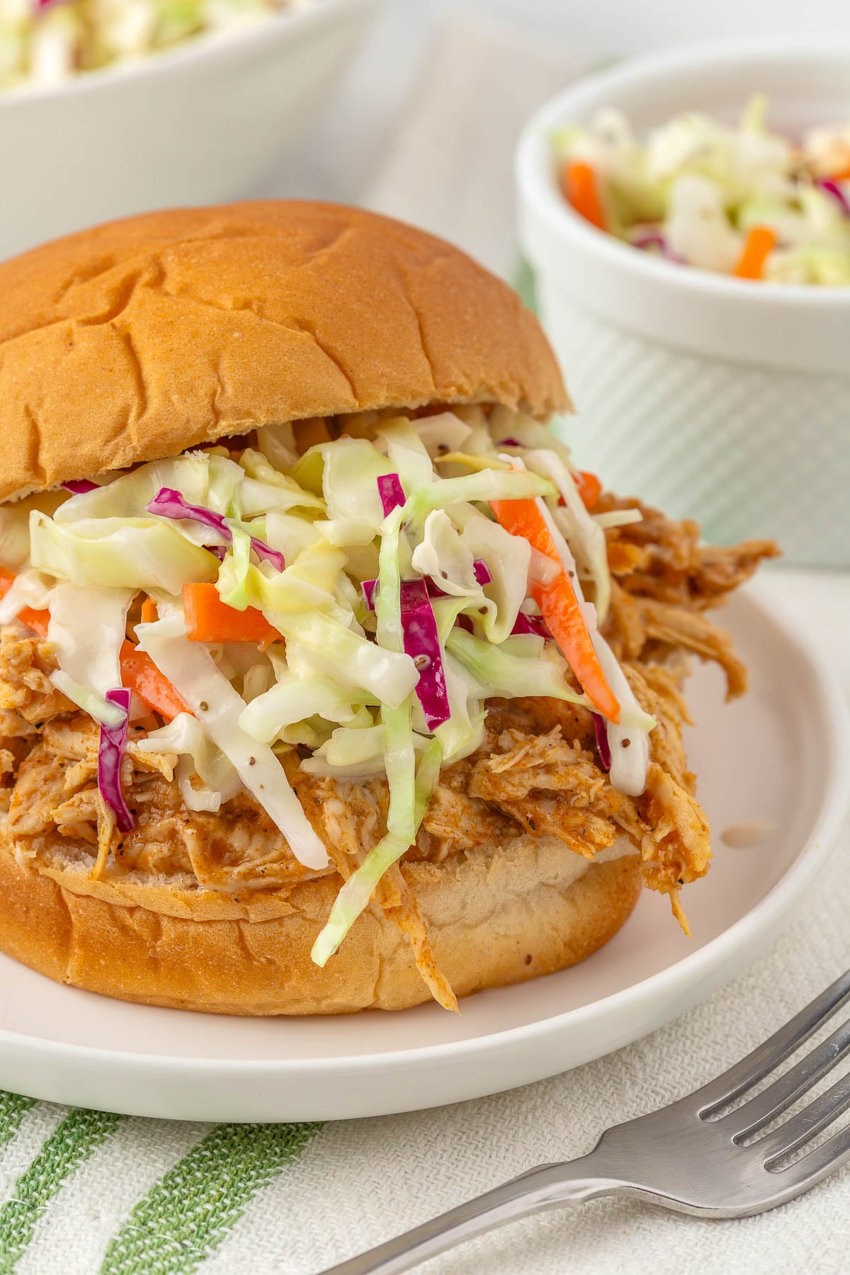pulled pork sandwich with coleslaw on top