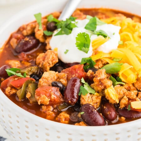 Ground chicken chili recipe in a bowl with cheese