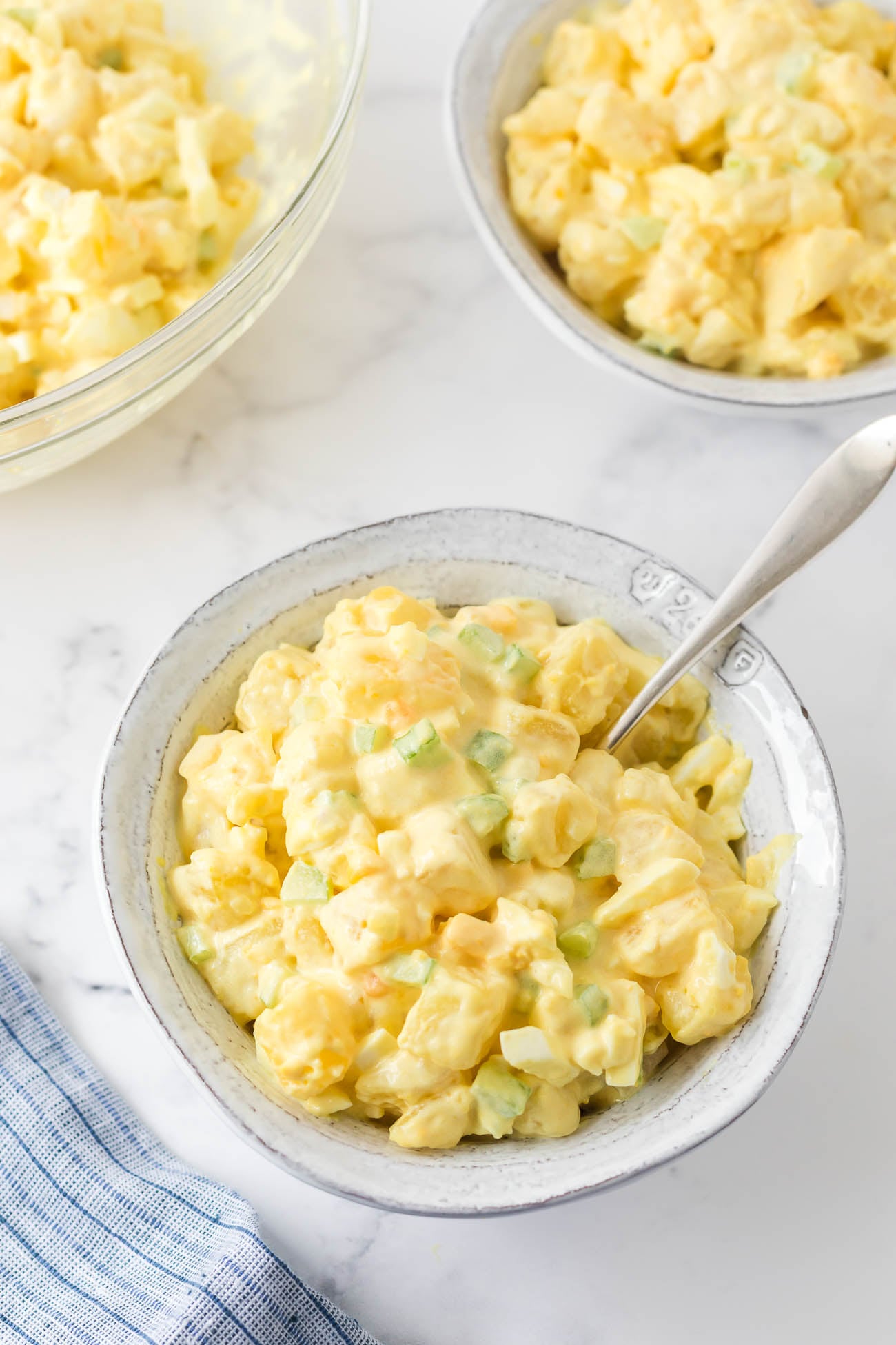 Amish Potato Salad in a serving bowl with creamy dressing and diced eggs