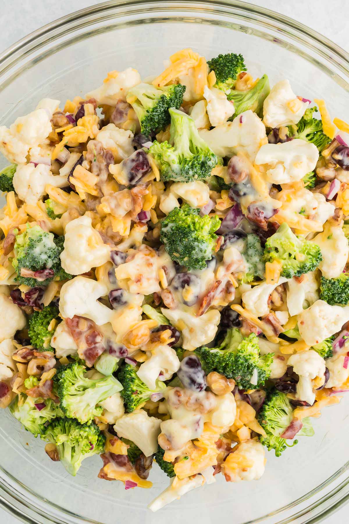 salad with broccoli and cauliflower in a bowl with cheese and bacon