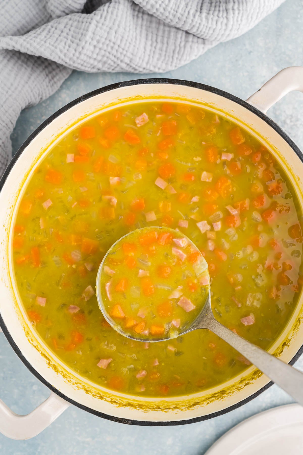 creamy split pea soup in a ladel