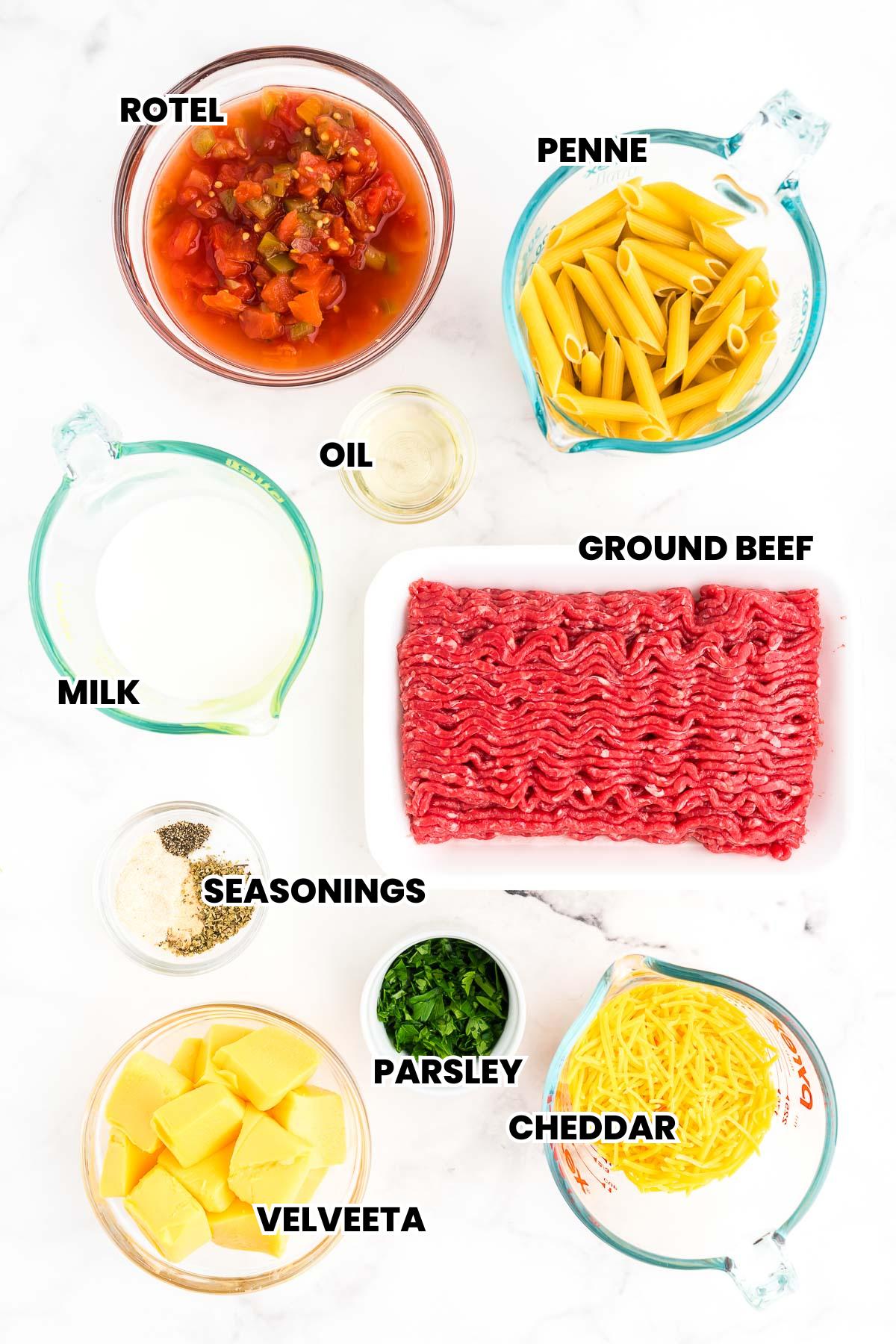 Ingredients for creamy ground beef pasta arranged on a counter