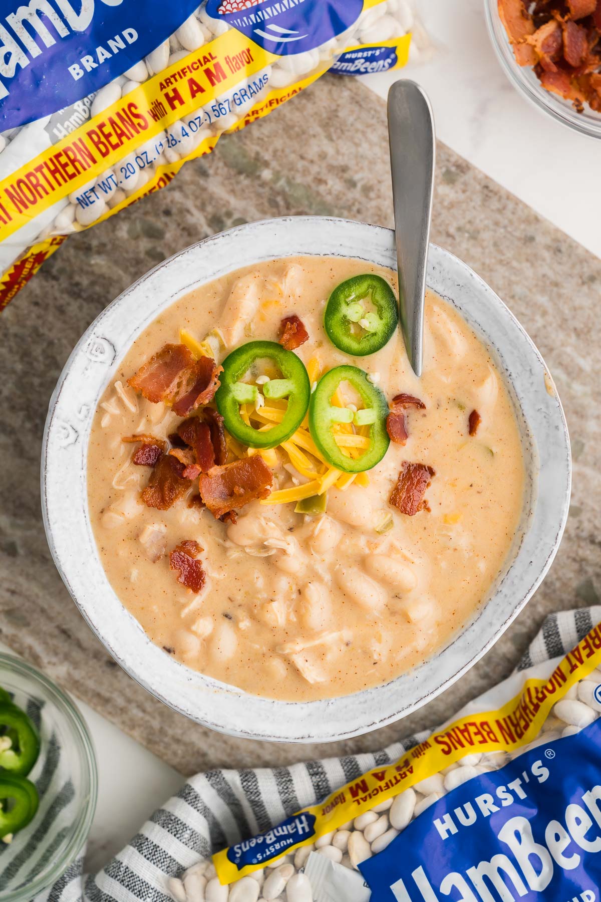 Close up of white chicken chili with melted cheese and tender shredded chicken.