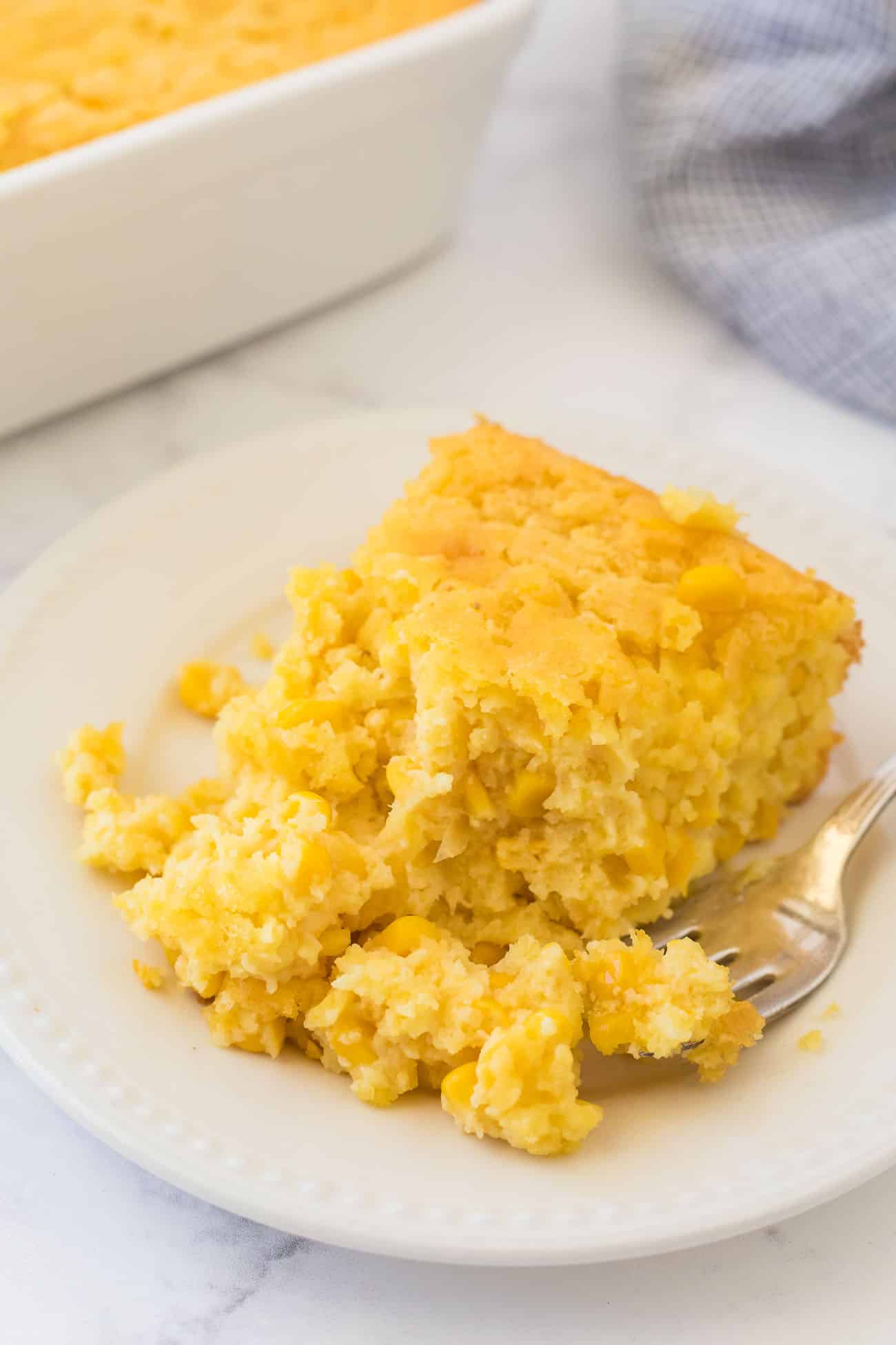 Spoonful of creamy buttery holiday side dish on a plate with fork.