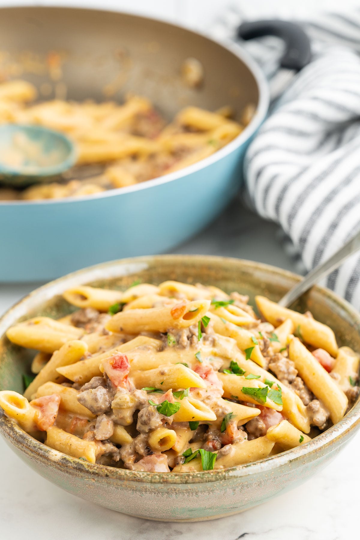 Scoop of cheesy pasta with Rotel tomatoes and green chilies