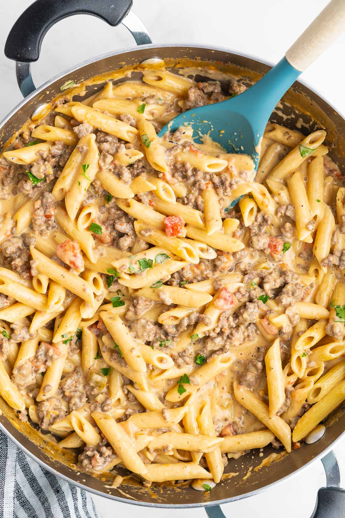 Close up of tender penne mixed with ground beef and melted cheese