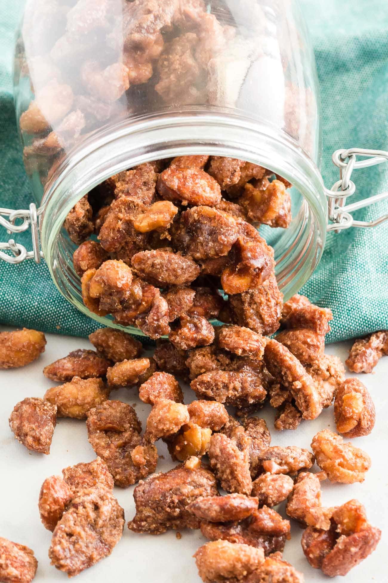 candied nuts being portioned into mason jars for hostess gifts