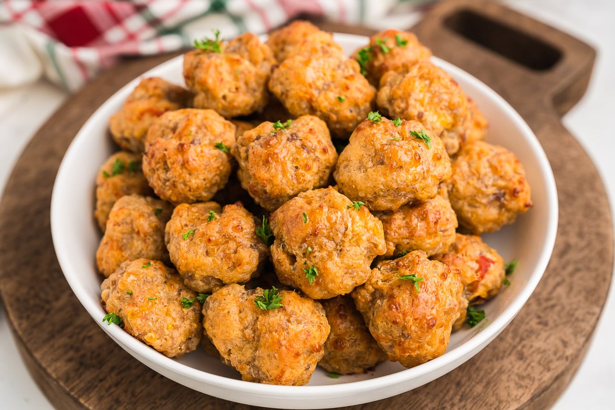 bite size holiday appetizer on a baking sheet with a golden, cheesy finish