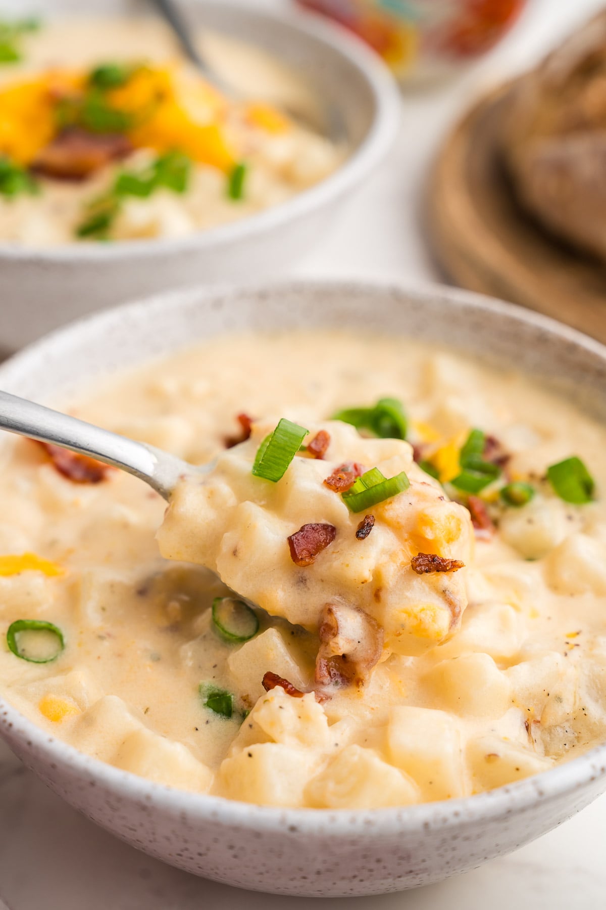 Close-up of a bowl of hash brown potato soup from the Crock Pot with crumbled bacon