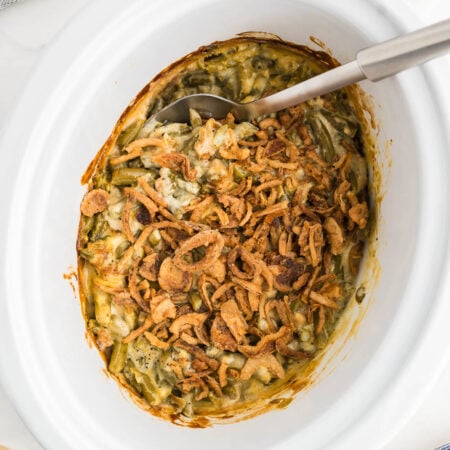Crockpot green bean casserole with crispy fried onions on top