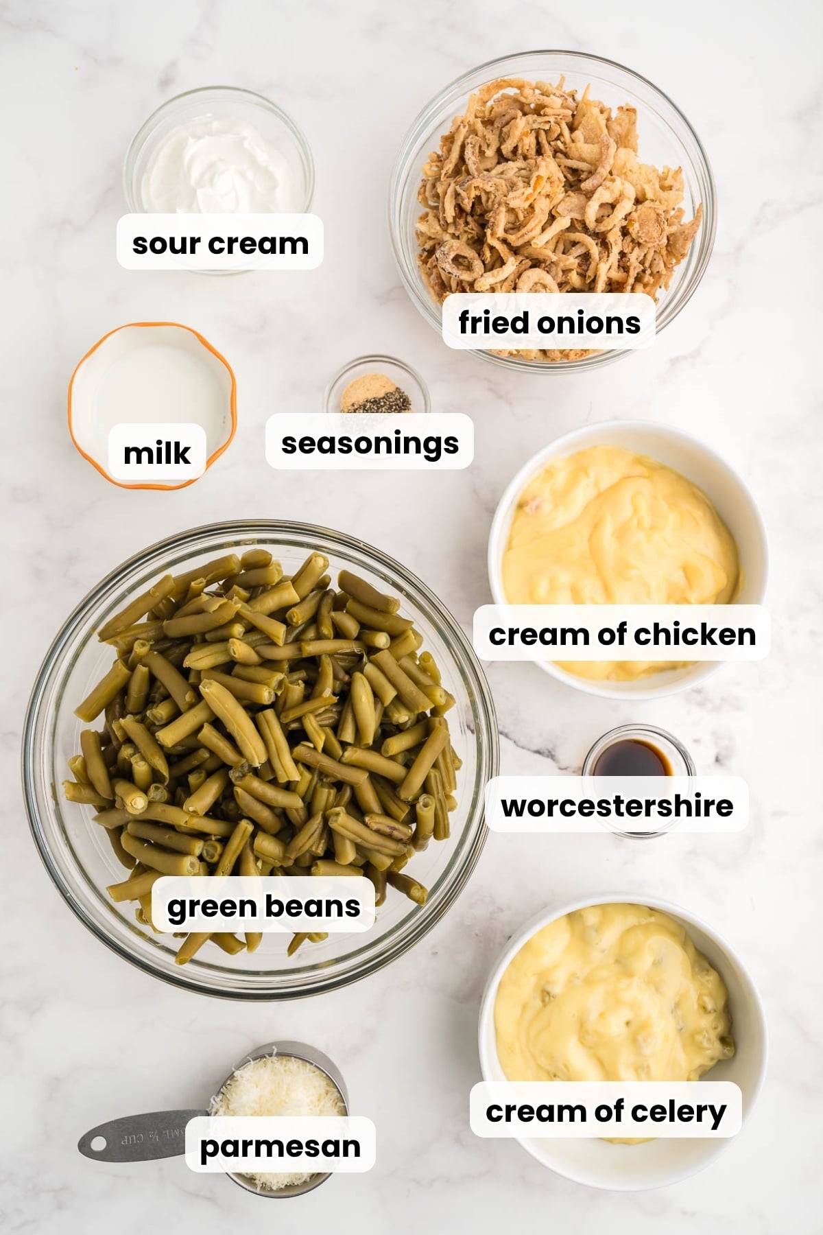 Ingredients for green bean casserole without mushroom soup: cream of chicken and cream of celery soup, sour cream, milk, seasonings, Worcestershire, Parmesan, canned green beans and fried onions