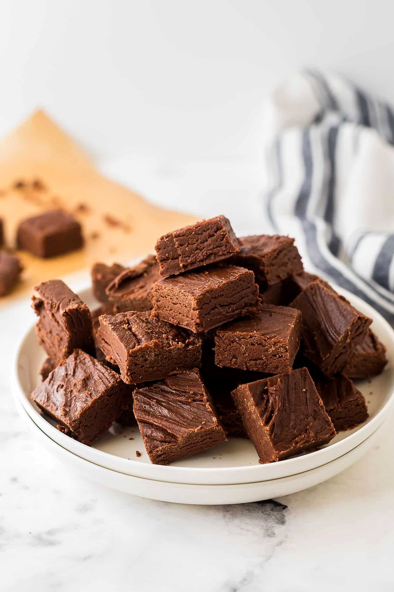 Evaporated milk fudge squares piled on a white plate