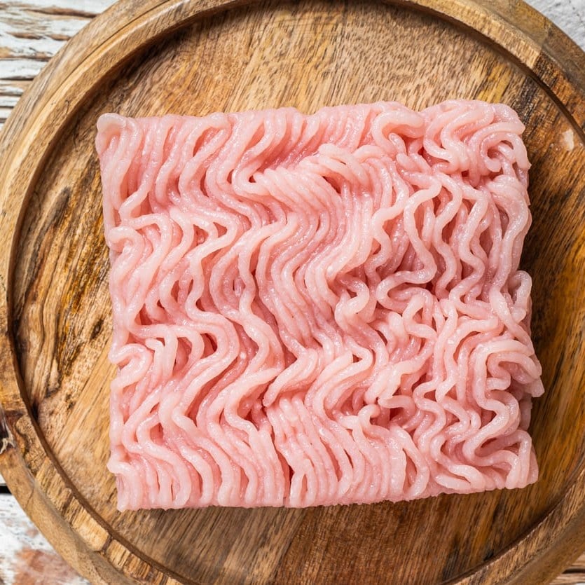 Raw ground pork on a wooden board