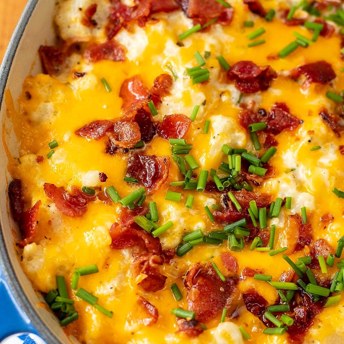 Loaded cauliflower casserole with cheddar, bacon and chives.