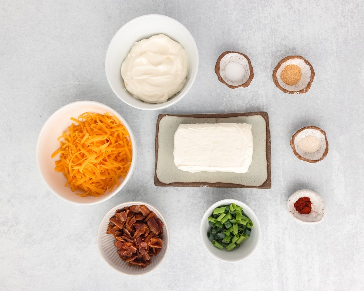Ingredients for million dollar dip: cream cheese, mayonnaise, shredded cheddar, bacon, green onions and seasonings